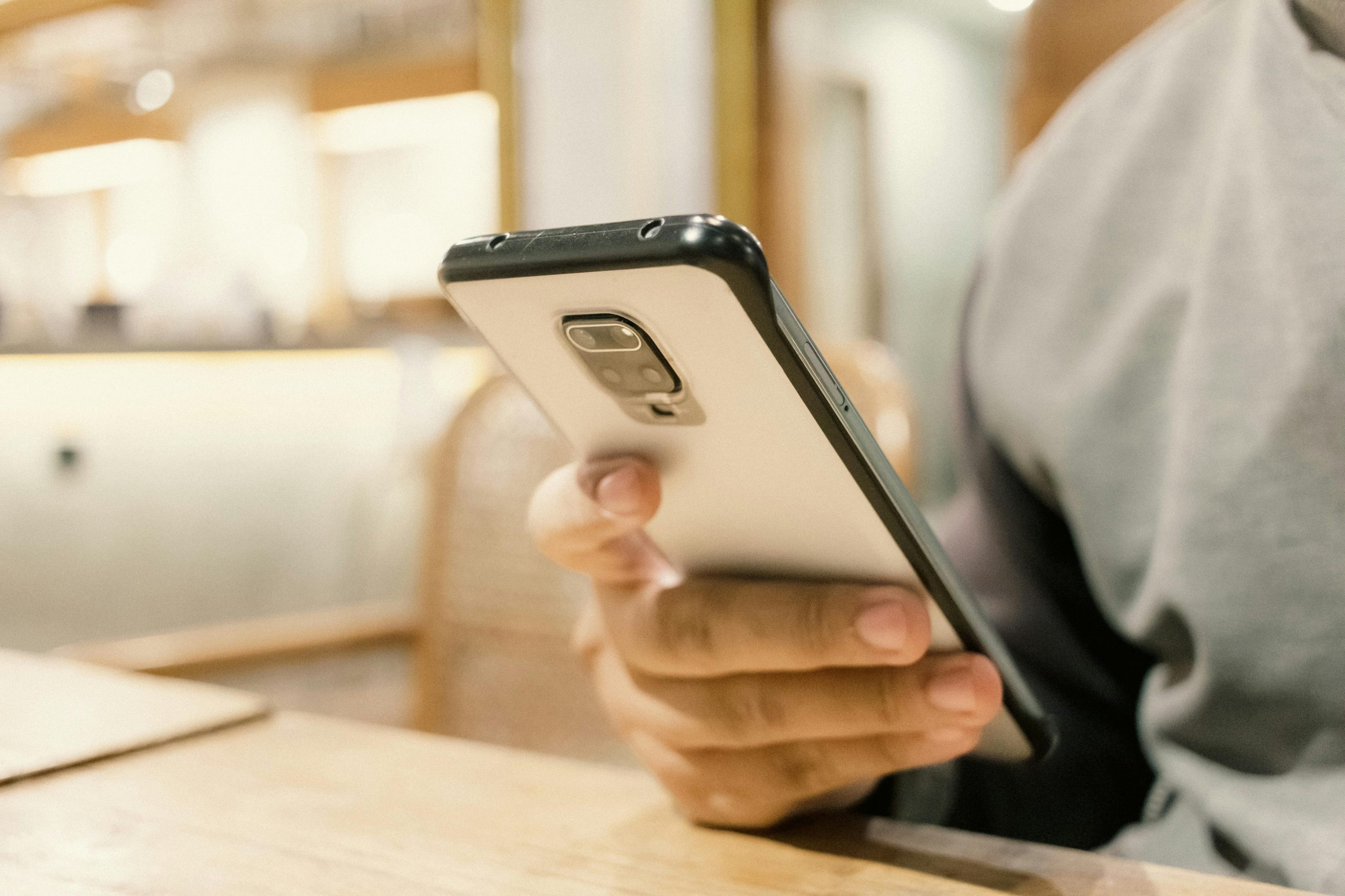 close-up of a hand gripping a smartphone